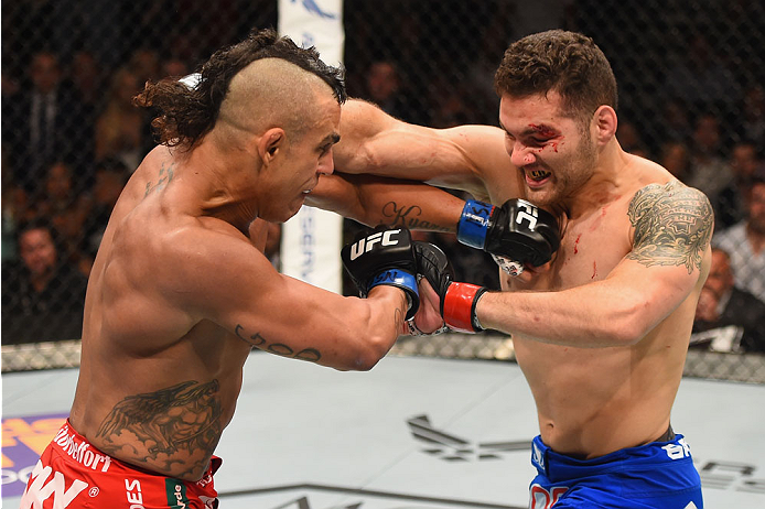 LAS VEGAS, NV - MAY 23: (L-R) Vitor Belfort of Brazil and Chris Weidman exchange punches in their UFC middleweight championship bout during the UFC 187 event at the MGM Grand Garden Arena on May 23, 2015 in Las Vegas, Nevada. (Photo by Josh Hedges/Zuffa