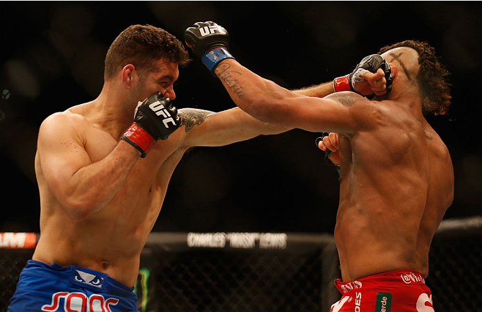 LAS VEGAS, NV - MAY 23:  (L-R) Chris Weidman punches Vitor Belfort of Brazil in their UFC middleweight championship bout during the UFC 187 event at the MGM Grand Garden Arena on May 23, 2015 in Las Vegas, Nevada.  (Photo by Christian Petersen/Zuffa LLC/Z