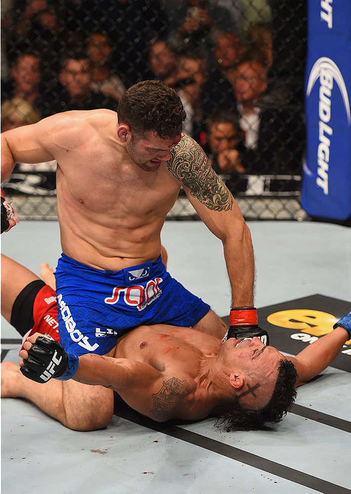 LAS VEGAS, NV - MAY 23:  Chris Weidman (top) punches Vitor Belfort of Brazil in their UFC middleweight championship bout during the UFC 187 event at the MGM Grand Garden Arena on May 23, 2015 in Las Vegas, Nevada.  (Photo by Josh Hedges/Zuffa LLC/Zuffa LL