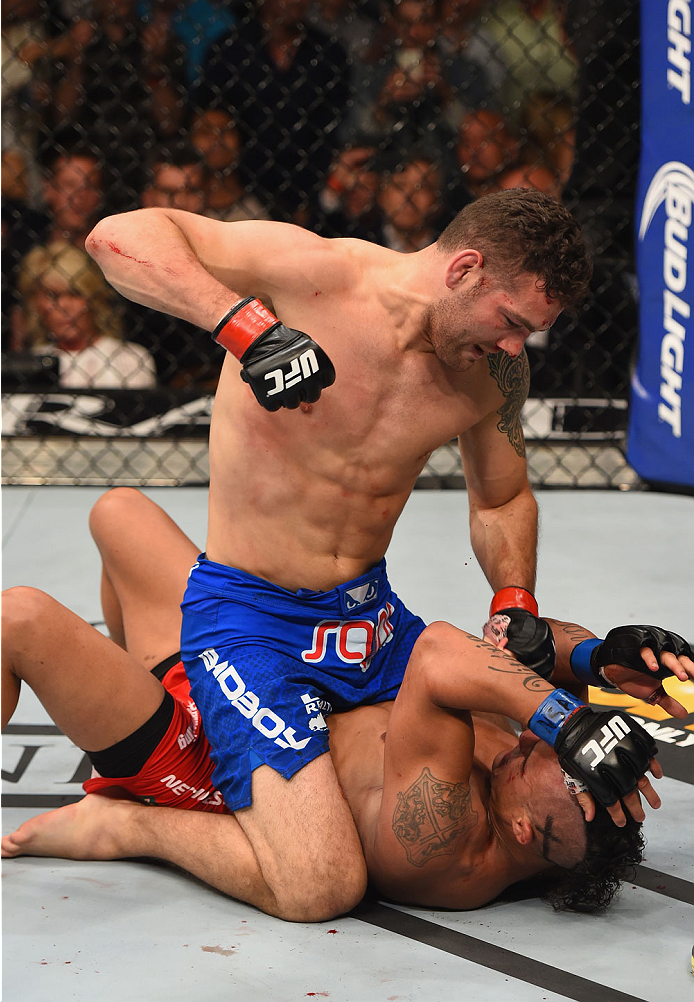 LAS VEGAS, NV - MAY 23:  Chris Weidman (top) punches Vitor Belfort of Brazil in their UFC middleweight championship bout during the UFC 187 event at the MGM Grand Garden Arena on May 23, 2015 in Las Vegas, Nevada.  (Photo by Josh Hedges/Zuffa LLC/Zuffa LL