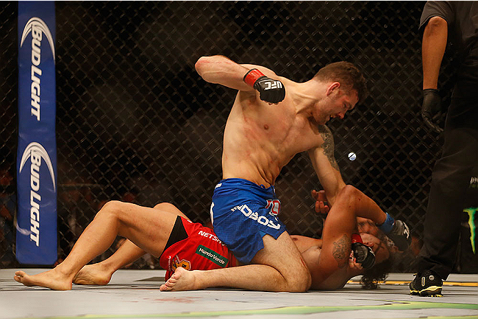 LAS VEGAS, NV - MAY 23: Chris Weidman (top) punches Vitor Belfort of Brazil in their UFC middleweight championship bout during the UFC 187 event at the MGM Grand Garden Arena on May 23, 2015 in Las Vegas, Nevada. (Photo by Christian Petersen/Zuffa LLC/Z