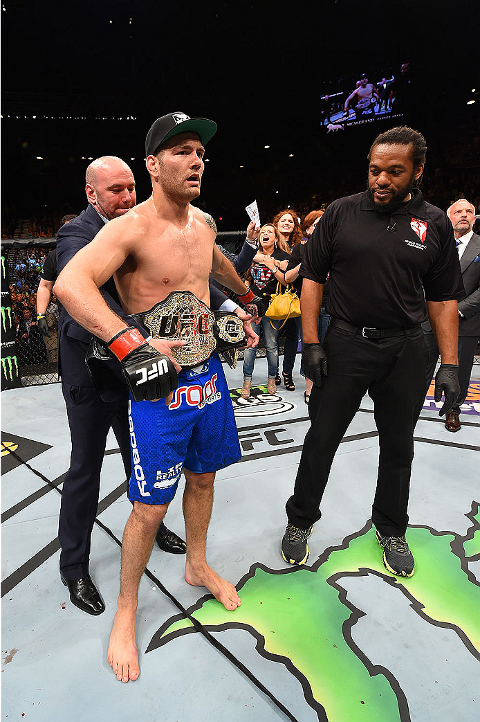 LAS VEGAS, NV - MAY 23:  (L-R) UFC president Dana White places the UFC middleweight title around Chris Weidman's waist during the UFC 187 event at the MGM Grand Garden Arena on May 23, 2015 in Las Vegas, Nevada.  (Photo by Josh Hedges/Zuffa LLC/Zuffa LLC 