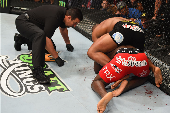 LAS VEGAS, NV - MAY 23: Daniel Cormier (black shorts) attempts to submit Anthony Johnson (red shorts) in their UFC light heavyweight championship bout during the UFC 187 event at the MGM Grand Garden Arena on May 23, 2015 in Las Vegas, Nevada. (Photo by