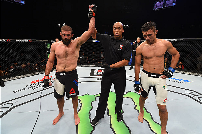 LAS VEGAS, NV - DECEMBER 12: Court McGee (left) is declared the winner over Marcio Alexandre of Brazil (right) in their welterweight bout during the UFC 194 event inside MGM Grand Garden Arena on December 12, 2015 in Las Vegas, Nevada.  (Photo by Josh Hed