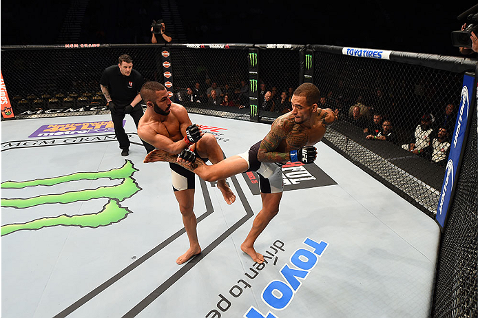 LAS VEGAS, NV - DECEMBER 12: (R-L) Yancy Medeiros kicks John Makedssi of Canada in their lightweight bout during the UFC 194 event inside MGM Grand Garden Arena on December 12, 2015 in Las Vegas, Nevada.  (Photo by Josh Hedges/Zuffa LLC/Zuffa LLC via Gett