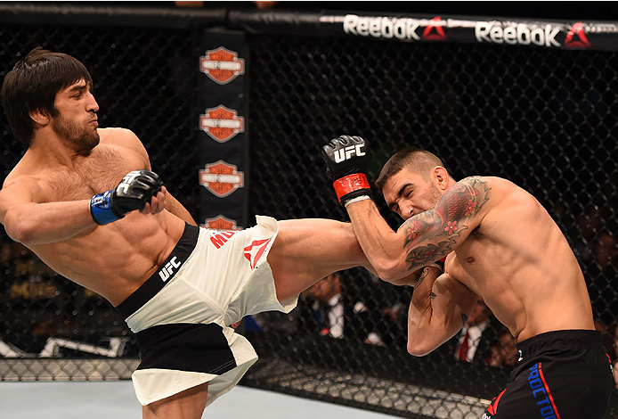 LAS VEGAS, NV - DECEMBER 12: (L-R) Magomed Mustafaev of Russia kicks Joe Proctor in their lightweight bout during the UFC 194 event inside MGM Grand Garden Arena on December 12, 2015 in Las Vegas, Nevada.  (Photo by Josh Hedges/Zuffa LLC/Zuffa LLC via Get