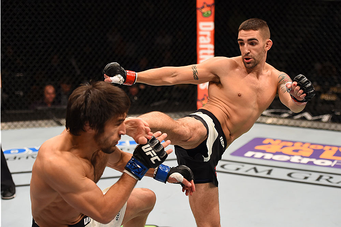 LAS VEGAS, NV - DECEMBER 12: (R-L) Joe Proctor kicks Magomed Mustafaev of Russia in their lightweight bout during the UFC 194 event inside MGM Grand Garden Arena on December 12, 2015 in Las Vegas, Nevada. (Photo by Josh Hedges/Zuffa LLC/Zuffa LLC via Ge