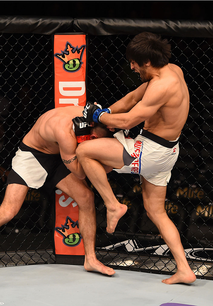 LAS VEGAS, NV - DECEMBER 12: (R-L) Magomed Mustafaev of Russia knees Joe Proctor in their lightweight bout during the UFC 194 event inside MGM Grand Garden Arena on December 12, 2015 in Las Vegas, Nevada. (Photo by Josh Hedges/Zuffa LLC/Zuffa LLC via Get