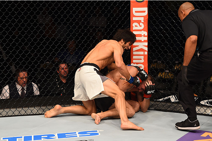 LAS VEGAS, NV - DECEMBER 12: Magomed Mustafaev of Russia (white shorts) punches Joe Proctor in their lightweight bout during the UFC 194 event inside MGM Grand Garden Arena on December 12, 2015 in Las Vegas, Nevada.  (Photo by Josh Hedges/Zuffa LLC/Zuffa 