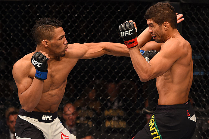 LAS VEGAS, NV - DECEMBER 12: (L-R) Kevin Lee punches Leonardo Santos of Brazil in their lightweight bout during the UFC 194 event inside MGM Grand Garden Arena on December 12, 2015 in Las Vegas, Nevada. (Photo by Josh Hedges/Zuffa LLC/Zuffa LLC via Getty