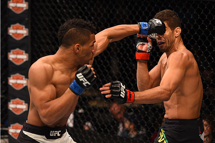 LAS VEGAS, NV - DECEMBER 12: (L-R) Kevin Lee punches Leonardo Santos of Brazil in their lightweight bout during the UFC 194 event inside MGM Grand Garden Arena on December 12, 2015 in Las Vegas, Nevada. (Photo by Josh Hedges/Zuffa LLC/Zuffa LLC via Getty