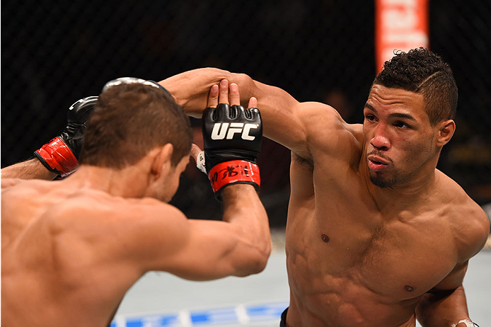 LAS VEGAS, NV - DECEMBER 12: (R-L) Kevin Lee punches Leonardo Santos of Brazil in their lightweight bout during the UFC 194 event inside MGM Grand Garden Arena on December 12, 2015 in Las Vegas, Nevada.  (Photo by Josh Hedges/Zuffa LLC/Zuffa LLC via Getty