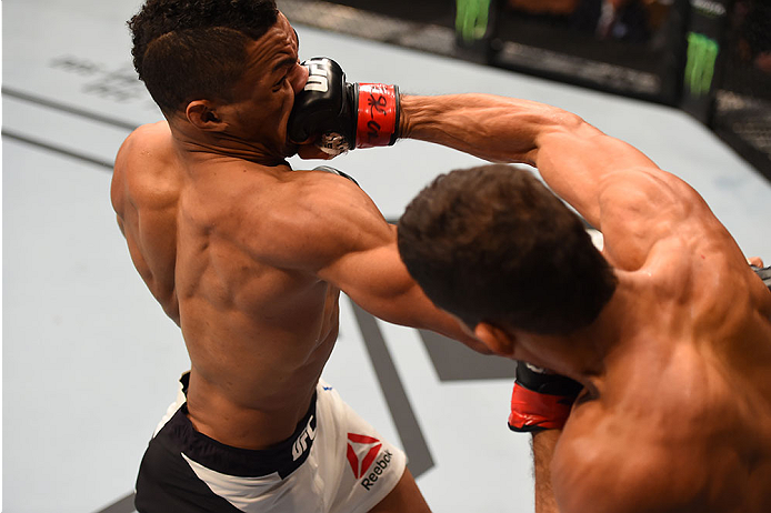 LAS VEGAS, NV - DECEMBER 12:  (R-L) Leonardo Santos of Brazil punches Kevin Lee in their lightweight bout during the UFC 194 event inside MGM Grand Garden Arena on December 12, 2015 in Las Vegas, Nevada.  (Photo by Josh Hedges/Zuffa LLC/Zuffa LLC via Gett