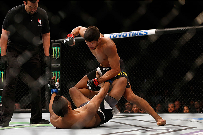 LAS VEGAS, NV - DECEMBER 12: Leonardo Santos of Brazil (black trunks) punches Kevin Lee in their lightweight bout during the UFC 194 event inside MGM Grand Garden Arena on December 12, 2015 in Las Vegas, Nevada. (Photo by Christian Petersen/Zuffa LLC/Zu