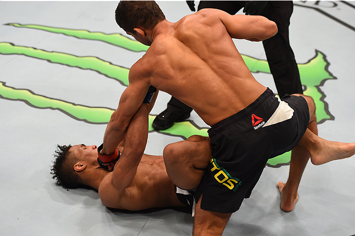 LAS VEGAS, NV - DECEMBER 12: (R-L) Leonardo Santos of Brazil punches Kevin Lee in their lightweight bout during the UFC 194 event inside MGM Grand Garden Arena on December 12, 2015 in Las Vegas, Nevada. (Photo by Josh Hedges/Zuffa LLC/Zuffa LLC via Getty