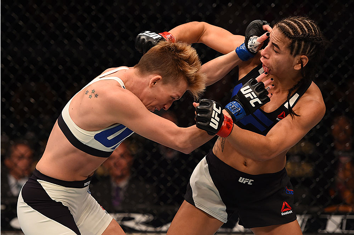 LAS VEGAS, NV - DECEMBER 12: (L-R) Jocelyn Jones-Lybarger punches Tecia Torres in their women's strawweight bout during the UFC 194 event inside MGM Grand Garden Arena on December 12, 2015 in Las Vegas, Nevada.  (Photo by Josh Hedges/Zuffa LLC/Zuffa LLC v