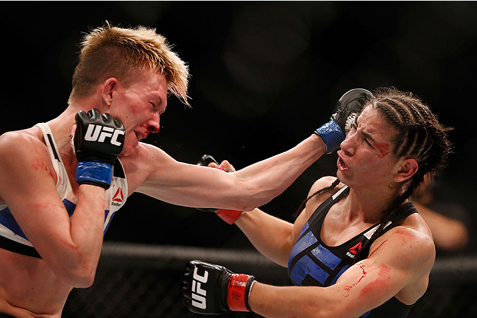 LAS VEGAS, NV - DECEMBER 12: (L-R) Jocelyn Jones-Lybarger punches Tecia Torres in their women's strawweight bout during the UFC 194 event inside MGM Grand Garden Arena on December 12, 2015 in Las Vegas, Nevada. (Photo by Christian Petersen/Zuffa LLC/Zuff