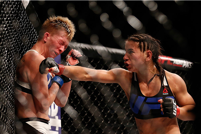 LAS VEGAS, NV - DECEMBER 12: (R-L) Tecia Torres punches Jocelyn Jones-Lybarger in their women's strawweight bout during the UFC 194 event inside MGM Grand Garden Arena on December 12, 2015 in Las Vegas, Nevada.  (Photo by Christian Petersen/Zuffa LLC/Zuff