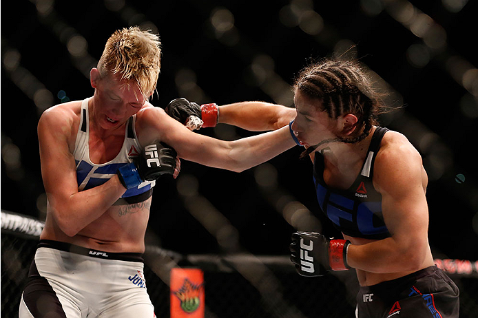 LAS VEGAS, NV - DECEMBER 12: (L-R) Jocelyn Jones-Lybarger and Tecia Torres exchange punches in their women's strawweight bout during the UFC 194 event inside MGM Grand Garden Arena on December 12, 2015 in Las Vegas, Nevada. (Photo by Christian Petersen/Z