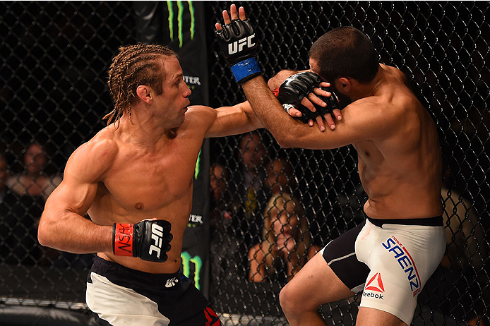 LAS VEGAS, NV - DECEMBER 12: (L-R) Urijah Faber punches Frankie Saenz in their bantamweight bout during the UFC 194 event inside MGM Grand Garden Arena on December 12, 2015 in Las Vegas, Nevada. (Photo by Josh Hedges/Zuffa LLC/Zuffa LLC via Getty Images)