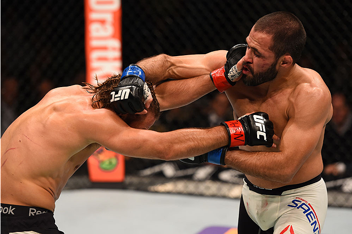 LAS VEGAS, NV - DECEMBER 12: (R-L) Frankie Saenz punches Urijah Faber in their bantamweight bout during the UFC 194 event inside MGM Grand Garden Arena on December 12, 2015 in Las Vegas, Nevada.  (Photo by Josh Hedges/Zuffa LLC/Zuffa LLC via Getty Images)