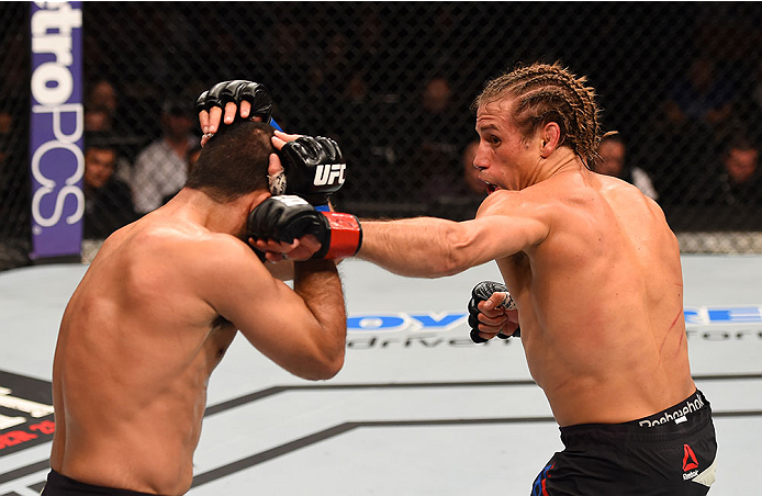 LAS VEGAS, NV - DECEMBER 12: (R-L) Urijah Faber punches Frankie Saenz in their bantamweight bout during the UFC 194 event inside MGM Grand Garden Arena on December 12, 2015 in Las Vegas, Nevada.  (Photo by Josh Hedges/Zuffa LLC/Zuffa LLC via Getty Images)