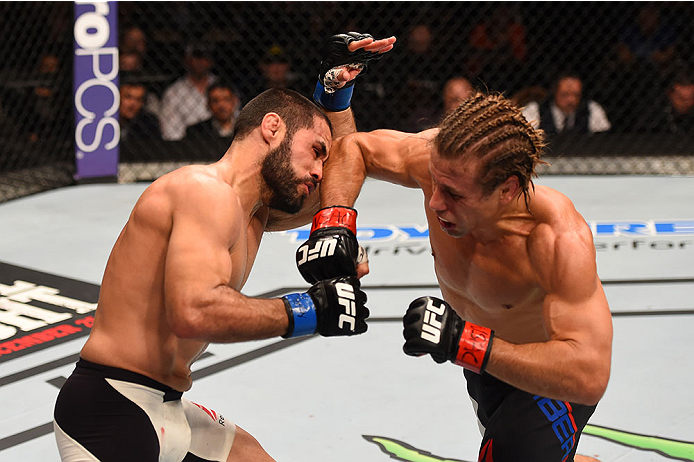 LAS VEGAS, NV - DECEMBER 12: (R-L) Urijah Faber punches Frankie Saenz in their bantamweight bout during the UFC 194 event inside MGM Grand Garden Arena on December 12, 2015 in Las Vegas, Nevada. (Photo by Josh Hedges/Zuffa LLC/Zuffa LLC via Getty Images)