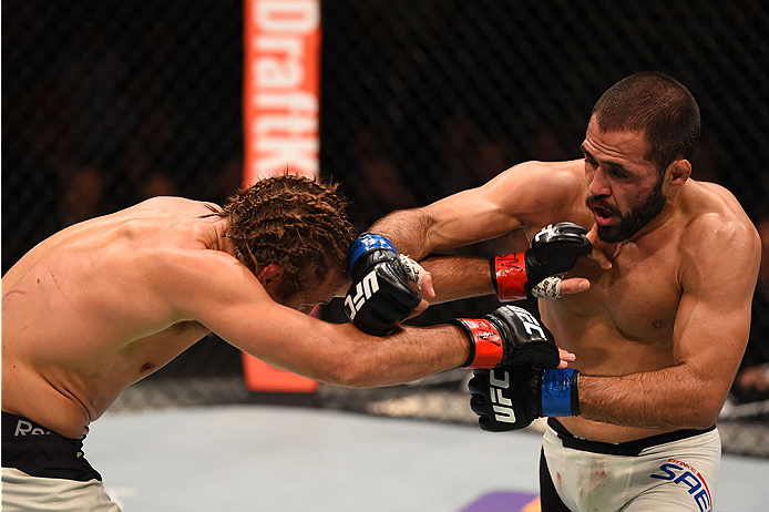 LAS VEGAS, NV - DECEMBER 12: (R-L) Frankie Saenz punches Urijah Faber in their bantamweight bout during the UFC 194 event inside MGM Grand Garden Arena on December 12, 2015 in Las Vegas, Nevada. (Photo by Josh Hedges/Zuffa LLC/Zuffa LLC via Getty Images)