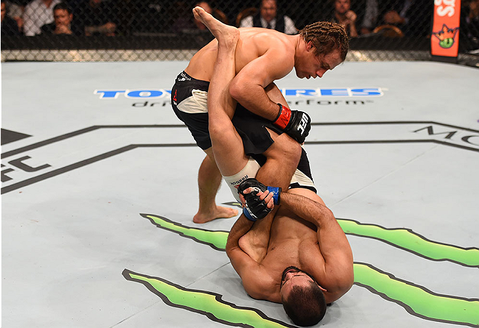 LAS VEGAS, NV - DECEMBER 12: Frankie Saenz (bottom) attempts to submit Urijah Faber in their bantamweight bout during the UFC 194 event inside MGM Grand Garden Arena on December 12, 2015 in Las Vegas, Nevada.  (Photo by Josh Hedges/Zuffa LLC/Zuffa LLC via