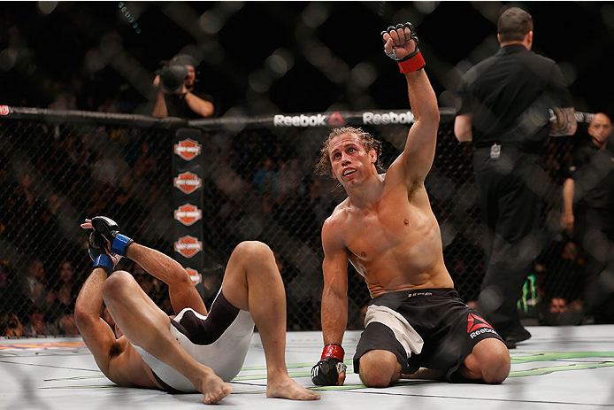 LAS VEGAS, NV - DECEMBER 12: Urijah Faber (right) reacts after his fight with Frankie Saenz (left) during the UFC 194 event inside MGM Grand Garden Arena on December 12, 2015 in Las Vegas, Nevada.  (Photo by Christian Petersen/Zuffa LLC/Zuffa LLC via Gett