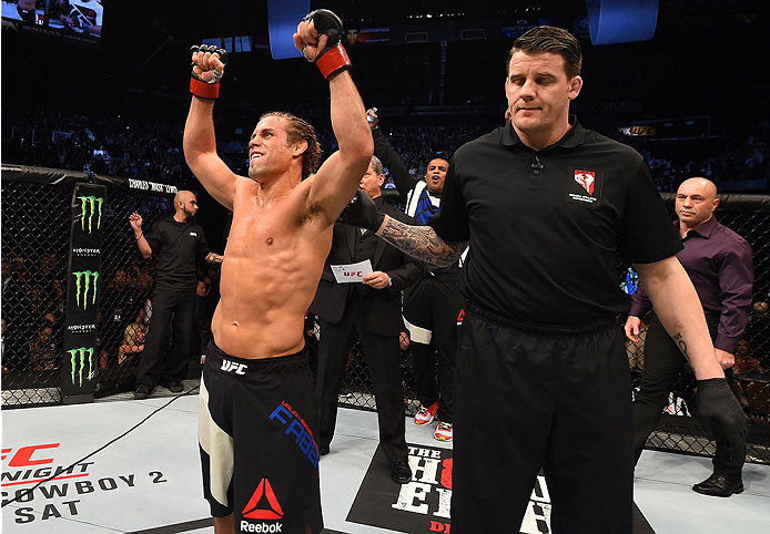 LAS VEGAS, NV - DECEMBER 12: Urijah Faber (left) reacts to his victory over Frankie Saenz in their bantamweight bout during the UFC 194 event inside MGM Grand Garden Arena on December 12, 2015 in Las Vegas, Nevada. (Photo by Josh Hedges/Zuffa LLC/Zuffa L