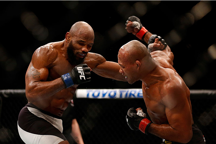 LAS VEGAS, NV - DECEMBER 12: (R-L) Ronaldo 'Jacare' Souza of Brazil punches Yoel Romero of Cuba in their middleweight bout during the UFC 194 event inside MGM Grand Garden Arena on December 12, 2015 in Las Vegas, Nevada. (Photo by Christian Petersen/Zuff