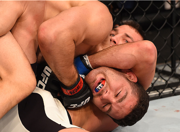 LAS VEGAS, NV - DECEMBER 12: Luke Rockhold (top) attempts to submit Chris Weidman in their UFC middleweight championship bout during the UFC 194 event inside MGM Grand Garden Arena on December 12, 2015 in Las Vegas, Nevada.  (Photo by Josh Hedges/Zuffa LL