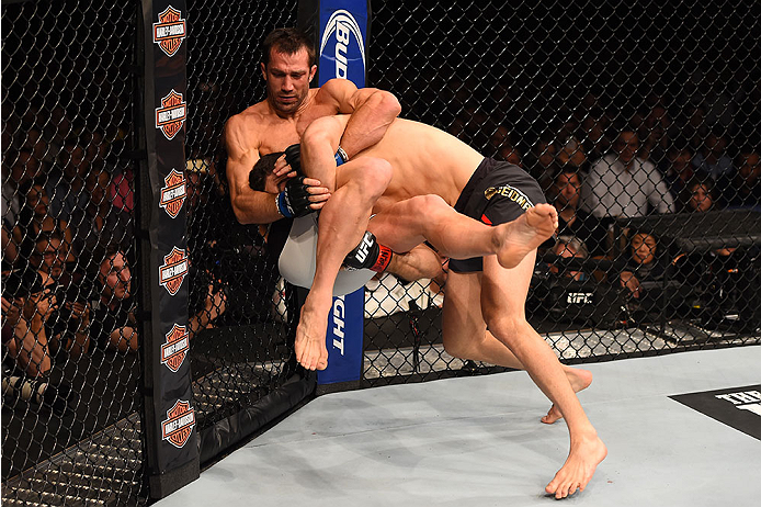 LAS VEGAS, NV - DECEMBER 12: Chris Weidman (right) takes down Luke Rockhold in their UFC middleweight championship bout during the UFC 194 event inside MGM Grand Garden Arena on December 12, 2015 in Las Vegas, Nevada.  (Photo by Josh Hedges/Zuffa LLC/Zuff