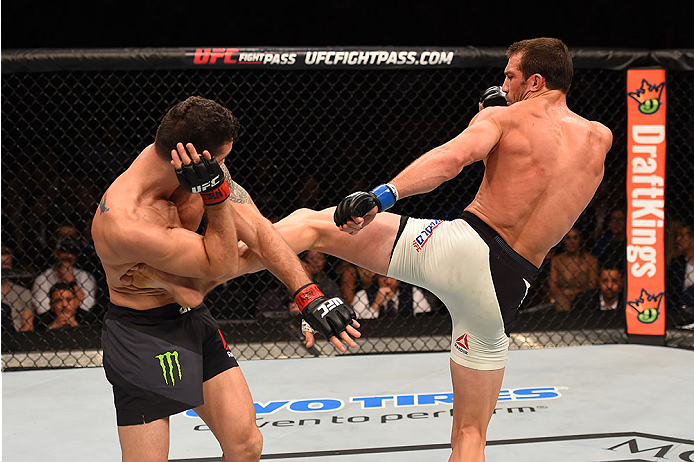 LAS VEGAS, NV - DECEMBER 12: (R-L) Luke Rockhold kicks Chris Weidman in their UFC middleweight championship bout during the UFC 194 event inside MGM Grand Garden Arena on December 12, 2015 in Las Vegas, Nevada.  (Photo by Josh Hedges/Zuffa LLC/Zuffa LLC v