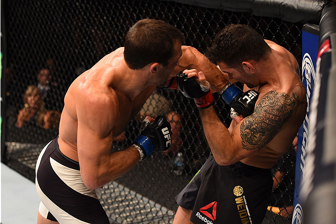 LAS VEGAS, NV - DECEMBER 12: (L-R) Luke Rockhold punches Chris Weidman in their UFC middleweight championship bout during the UFC 194 event inside MGM Grand Garden Arena on December 12, 2015 in Las Vegas, Nevada.  (Photo by Josh Hedges/Zuffa LLC/Zuffa LLC