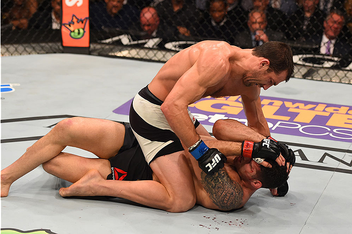 LAS VEGAS, NV - DECEMBER 12: Luke Rockhold (top) punches Chris Weidman in their UFC middleweight championship bout during the UFC 194 event inside MGM Grand Garden Arena on December 12, 2015 in Las Vegas, Nevada.  (Photo by Josh Hedges/Zuffa LLC/Zuffa LLC