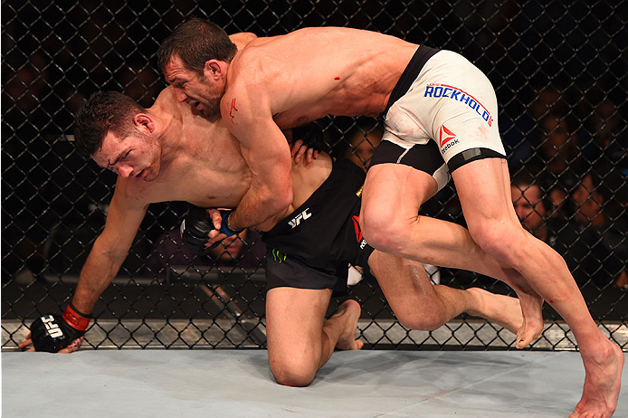 LAS VEGAS, NV - DECEMBER 12: Luke Rockhold (right) takes down Chris Weidman in their UFC middleweight championship bout during the UFC 194 event inside MGM Grand Garden Arena on December 12, 2015 in Las Vegas, Nevada.  (Photo by Josh Hedges/Zuffa LLC/Zuff