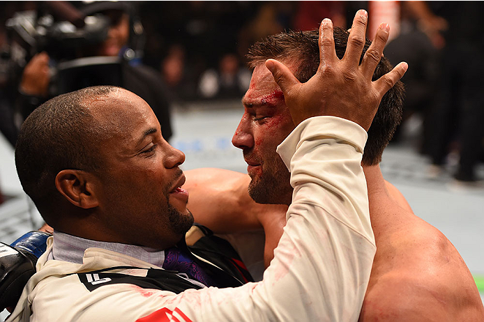 LAS VEGAS, NV - DECEMBER 12:  (L-R) UFC light heavyweight champion Daniel Cormier celebrates with Luke Rockhold after his victory over Chris Weidman in their UFC middleweight championship bout during the UFC 194 event inside MGM Grand Garden Arena on Dece