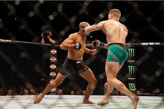 LAS VEGAS, NV - DECEMBER 12: (R-L) Conor McGregor of Ireland punches Jose Aldo of Brazil in their UFC welterweight championship bout during the UFC 194 event inside MGM Grand Garden Arena on December 12, 2015 in Las Vegas, Nevada. (Photo by Christian Pet