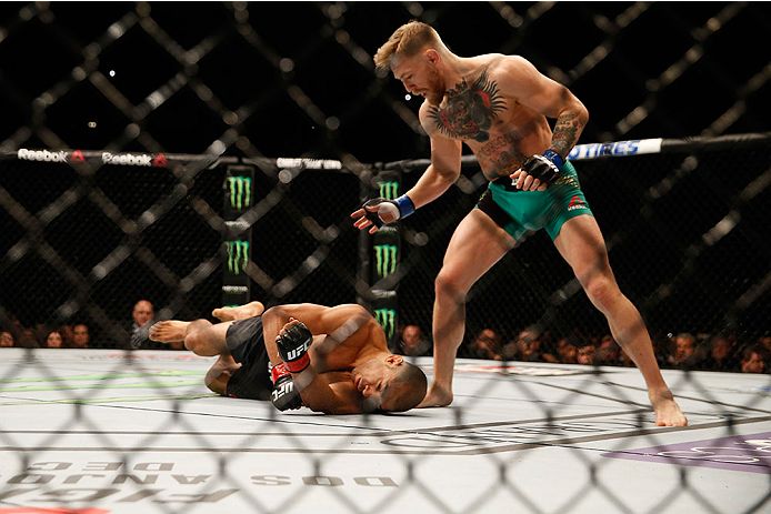 LAS VEGAS, NV - DECEMBER 12:  (R-L) Conor McGregor of Ireland punches Jose Aldo of Brazil in their UFC featherweight championship bout during the UFC 194 event inside MGM Grand Garden Arena on December 12, 2015 in Las Vegas, Nevada.  (Photo by Christian P