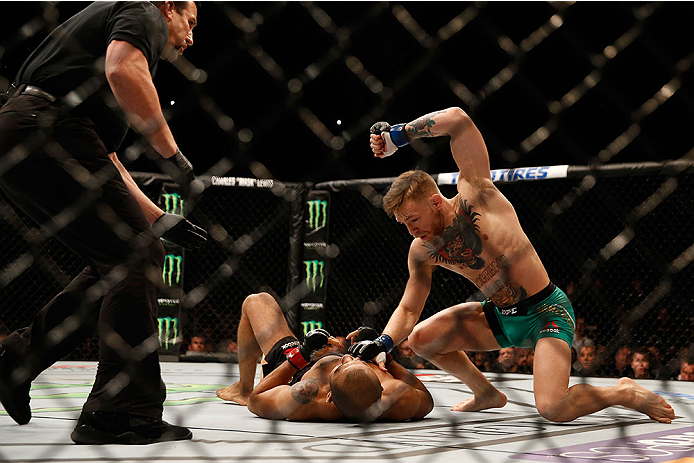 LAS VEGAS, NV - DECEMBER 12: Conor McGregor of Ireland (top) punches Jose Aldo of Brazil in their UFC featherweight championship bout during the UFC 194 event inside MGM Grand Garden Arena on December 12, 2015 in Las Vegas, Nevada. (Photo by Christian P