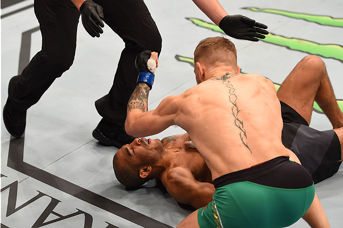 LAS VEGAS, NV - DECEMBER 12: Conor McGregor of Ireland (front) punches Jose Aldo of Brazil in their UFC featherweight championship bout during the UFC 194 event inside MGM Grand Garden Arena on December 12, 2015 in Las Vegas, Nevada. (Photo by Josh Hedg