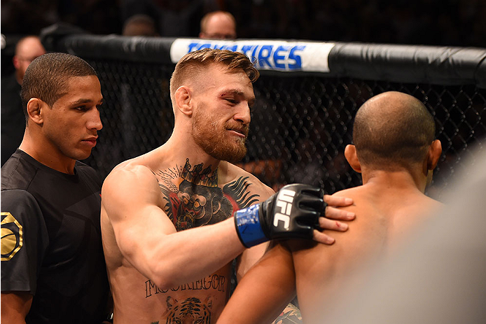 LAS VEGAS, NV - DECEMBER 12: Conor McGregor of Ireland (center) speaks to Jose Aldo of Brazil after their UFC featherweight championship bout during the UFC 194 event inside MGM Grand Garden Arena on December 12, 2015 in Las Vegas, Nevada. (Photo by Josh
