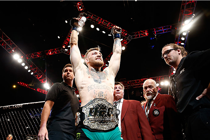 LAS VEGAS, NV - DECEMBER 12: Conor McGregor of Ireland exits the Octagon after his victory over Jose Aldo of Brazil in their UFC featherweight championship bout during the UFC 194 event inside MGM Grand Garden Arena on December 12, 2015 in Las Vegas, Nev