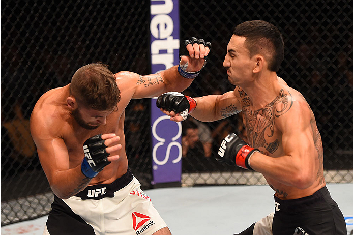 LAS VEGAS, NV - DECEMBER 12: (R-L) Max Holloway punches Jeremy Stephens in their featherweight bout during the UFC 194 event inside MGM Grand Garden Arena on December 12, 2015 in Las Vegas, Nevada.  (Photo by Josh Hedges/Zuffa LLC/Zuffa LLC via Getty Imag