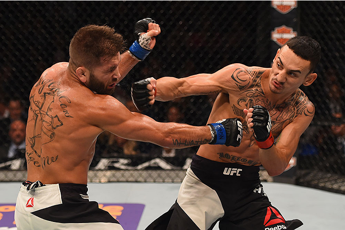 LAS VEGAS, NV - DECEMBER 12: (R-L) Max Holloway punches Jeremy Stephens in their featherweight bout during the UFC 194 event inside MGM Grand Garden Arena on December 12, 2015 in Las Vegas, Nevada.  (Photo by Josh Hedges/Zuffa LLC/Zuffa LLC via Getty Imag