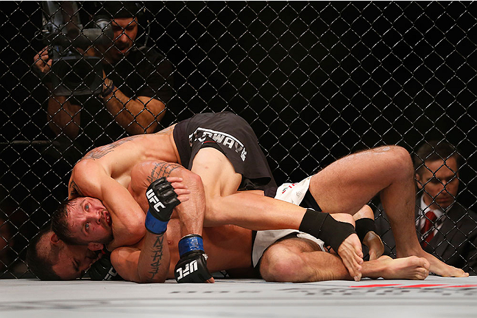 LAS VEGAS, NV - DECEMBER 12: Max Holloway (top) attempts to submit Jeremy Stephens in their featherweight bout during the UFC 194 event inside MGM Grand Garden Arena on December 12, 2015 in Las Vegas, Nevada.  (Photo by Christian Petersen/Zuffa LLC/Zuffa 