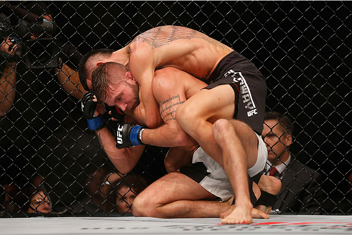 LAS VEGAS, NV - DECEMBER 12: Max Holloway (top) attempts to submit Jeremy Stephens in their featherweight bout during the UFC 194 event inside MGM Grand Garden Arena on December 12, 2015 in Las Vegas, Nevada.  (Photo by Christian Petersen/Zuffa LLC/Zuffa 