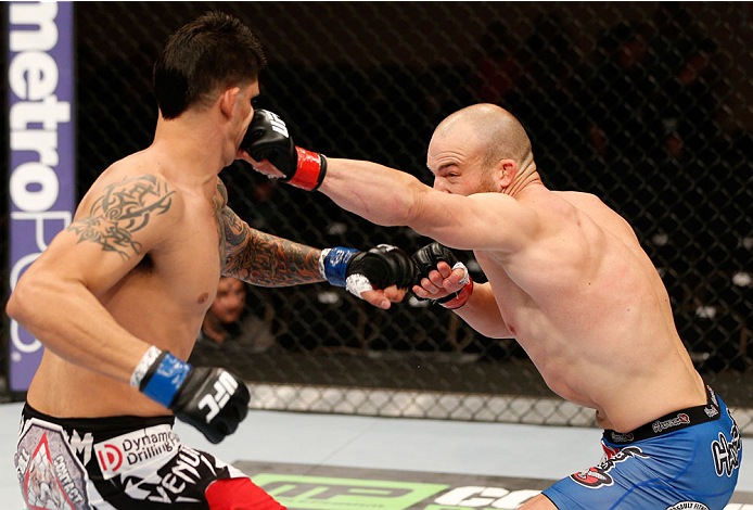 ALBUQUERQUE, NM - JUNE 07: (R-L) Patrick Cummins punches Roger Narvaez in their light heavyweight fight during the UFC Fight Night event at Tingley Coliseum on June 7, 2014 in Albuquerque, New Mexico. (Photo by Josh Hedges/Zuffa LLC/Zuffa LLC via Getty